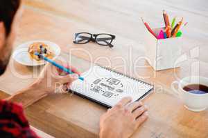 Composite image of creative businessman writing notes on noteboo