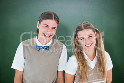 Composite image of smiling geeky hipsters looking at camera