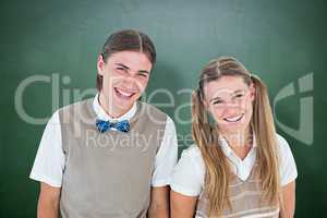 Composite image of smiling geeky hipsters looking at camera