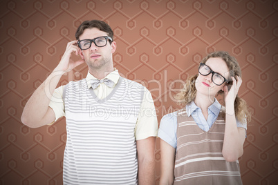 Composite image of geeky hipster couple thinking with hand on te