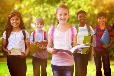 Composite image of smiling little school kids in school corridor