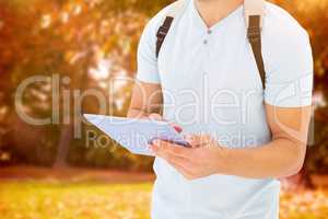 Composite image of student using tablet pc
