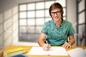 Composite image of student sitting in library writing