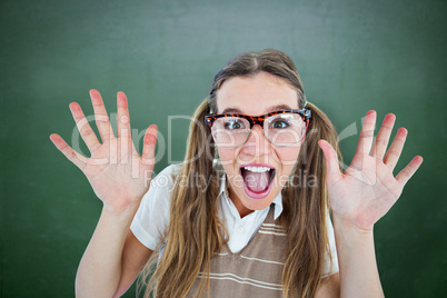 Composite image of female geeky hipster smiling at camera