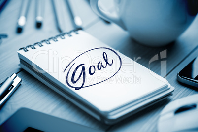 Goal  against notepad on desk