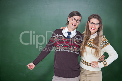 Composite image of happy geeky hipster couple embracing