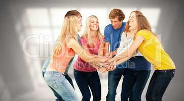 Composite image of group of friends about to cheer with their ha