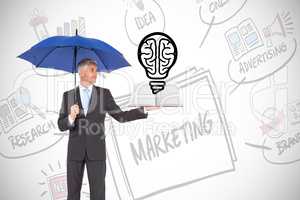 Composite image of businessman showing a book