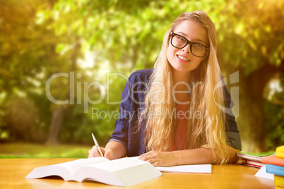 Composite image of student studying in the library