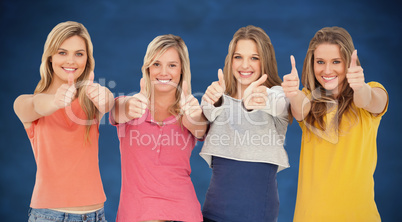 Composite image of girls sticking their thumbs up