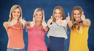 Composite image of girls sticking their thumbs up