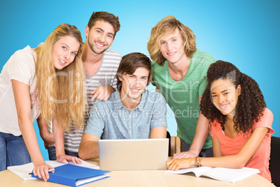 Composite image of college students using laptop in library