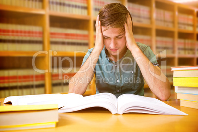 Composite image of student sitting in library reading