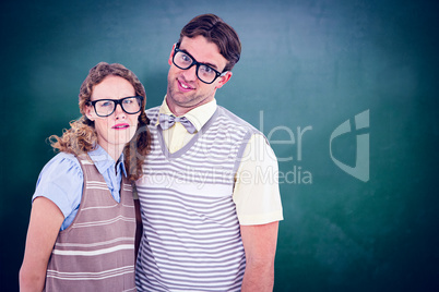 Composite image of happy geeky hipster couple with silly faces