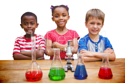 Composite image of cute pupils standing with arms crossed behind