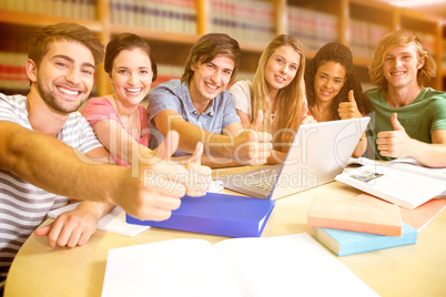 Composite image of college students gesturing thumbs up in libra