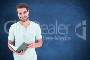 Composite image of student holding book