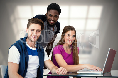 Composite image of creative team using laptop