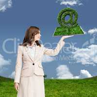 Composite image of woman holding lawn book