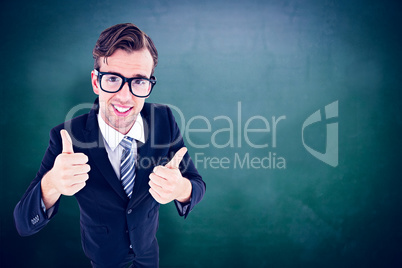 Composite image of geeky hipster smiling at camera with thumbs u