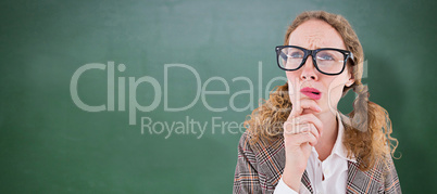 Composite image of geeky hipster woman thinking with hand on chi