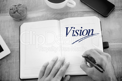 Vision  against man writing notes on diary