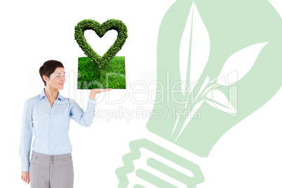 Composite image of woman holding lawn book