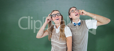 Composite image of geeky hipsters looking confused