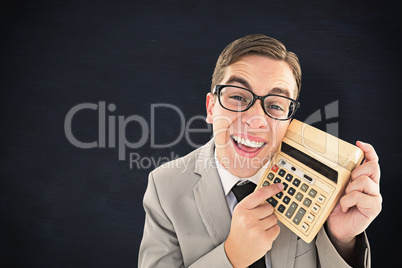 Composite image of geeky smiling businessman showing calculator