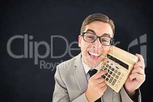 Composite image of geeky smiling businessman showing calculator