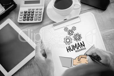 Composite image of man writing on clipboard on working desk