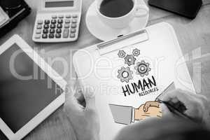 Composite image of man writing on clipboard on working desk