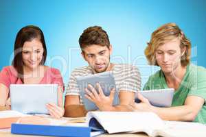 Composite image of college students using digital tablets in lib