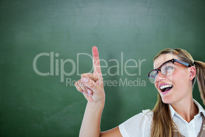 Composite image of happy geeky hipster pointing