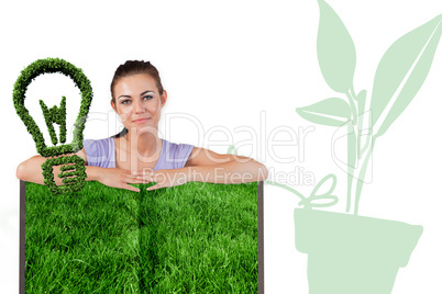 Composite image of woman with lawn book