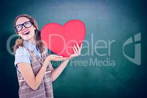 Composite image of geeky hipster woman holding heart card