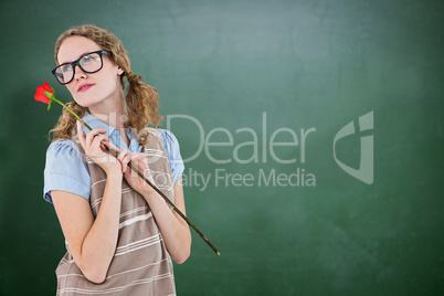 Composite image of geeky hipster woman holding rose