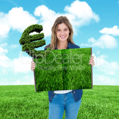 Composite image of woman holding lawn book