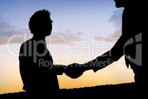 Composite image of silhouettes shaking hands