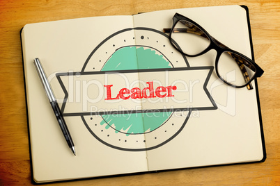 Leader against overhead of open notebook with pen and glasses