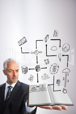 Composite image of businessman showing a book