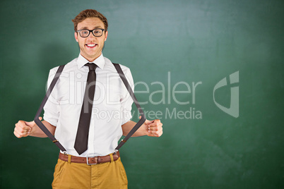 Composite image of geeky businessman pulling his suspenders