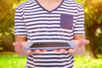 Composite image of close up of man holding tablet