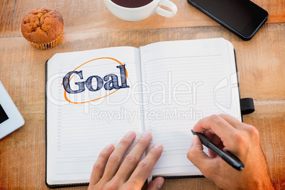 Goal  against man writing notes on diary