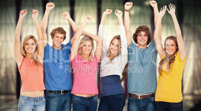 Composite image of a group of people with their hands raised