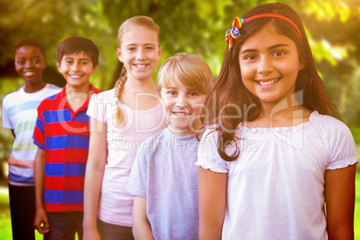 Composite image of smiling little school kids in school corridor