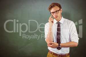 Composite image of young businessman thinking looking at camera