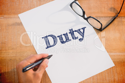 Duty against left hand writing on white page on working desk