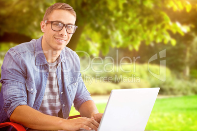 Composite image of hipster on laptop