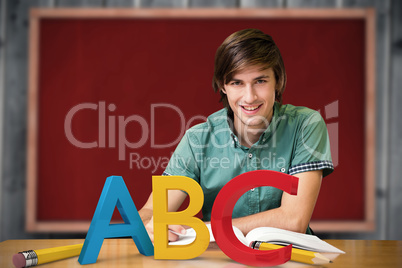 Composite image of student sitting in library reading